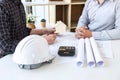 Team of architects or engineering consulting and analyzing working on objects tools and construction drawings inspection, Royalty Free Stock Photo