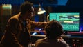 Team of artists collaborating on editing recorded tracks with audio software Royalty Free Stock Photo