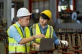 Team of Asian engineer worker inspecting inside the steel manufacturing factory while listening to senior manager advice on Royalty Free Stock Photo