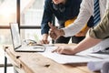 Team of Asian engineers and architects successful in building a project working showing thumbs up and looking at laptop Royalty Free Stock Photo