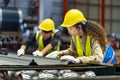 Team of Asian industrial worker is checking the setup value of metal sheet roll forming machine inside roof factory for safety Royalty Free Stock Photo