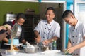 Team of asian male  pastry chef happy work together while pr eparing batter Royalty Free Stock Photo