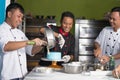 Team of asian male  pastry chef happy work together while preparing batter inside Royalty Free Stock Photo