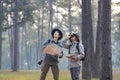 Team of the Asian naturalist looking at the map while exploring in the pine forest for surveying and discovering the rare