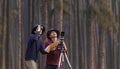 Team of the Asian naturalist looking at the new discovering bird species while exploring in the pine forest for surveying and