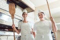 Team of baker women standing in bakery giving thumbs up