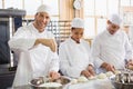 Team of bakers preparing dough Royalty Free Stock Photo