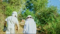 Team of beekeepers walking to the apiary