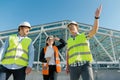 Team of builders engineer architect on the roof of construction site. Building, development, teamwork and people concept Royalty Free Stock Photo