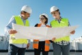 Team of builders engineer architect on the roof of construction site. Building, development, teamwork and people concept Royalty Free Stock Photo