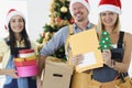 Team of builders are holding gift boxes and tools on background of New Year tree