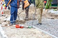 A team of builders is preparing the foundation for the paving of the sidewalk Royalty Free Stock Photo