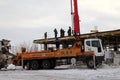 The team of builders working on the construction of the building in Novosibirsk, in the winter of poured concrete using a special