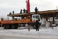 The team of builders working on the construction of the building in Novosibirsk, in the winter of poured concrete using a special