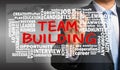 team building with related word cloud hand drawing by businessman Royalty Free Stock Photo