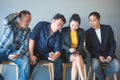 Team of business asian people is excited about the information on the smartphone of the group members while waiting for a job Royalty Free Stock Photo