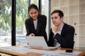 Team business of diverse partner business woman discuss project on laptop sitting at table in office. Two colleague of Royalty Free Stock Photo