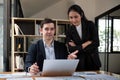 Team business of diverse partner business woman discuss project on laptop sitting at table in office. Two colleague of Royalty Free Stock Photo