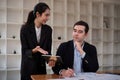 Team business of diverse partner business woman discuss project on laptop sitting at table in office. Two colleague of Royalty Free Stock Photo