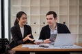 Team business of diverse partner business woman discuss project on laptop sitting at table in office. Two colleague of Royalty Free Stock Photo