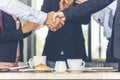 Team Business Partners shaking hands together to Greeting Start up small business in meeting room. Shakehand teamwork partners at Royalty Free Stock Photo