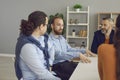 Young company manager or business mentor talking to diverse workers in office meeting Royalty Free Stock Photo