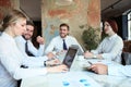 Team of business people having discussion at table in creative office Royalty Free Stock Photo