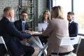 Team of business people having discussion at table in creative office Royalty Free Stock Photo