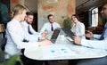 Team of business people having discussion at table in creative office Royalty Free Stock Photo