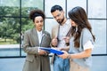 Team of business people talking in front of office building. Staff meeting quick briefing of office workers on motivational speech Royalty Free Stock Photo