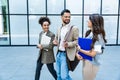 Team of business people talking in front of office building. Staff meeting quick briefing of office workers on motivational speech Royalty Free Stock Photo