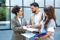 Team of business people talking in front of office building. Staff meeting quick briefing of office workers on motivational speech Royalty Free Stock Photo