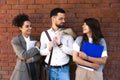 Team of business people talking in front of office building. Staff meeting quick briefing of office workers on motivational speech Royalty Free Stock Photo