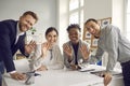 Team of business people waving hello at camera greeting international coworkers in online meeting Royalty Free Stock Photo