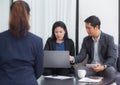 Team of business three people working together on a laptop. Royalty Free Stock Photo