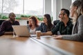 Candid low angle image of businesspeople discussing work during an office meeting Royalty Free Stock Photo