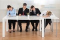 Businesspeople Getting Bored While Working In Office