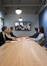 Team of businesspeople meeting at table in small conference room Royalty Free Stock Photo