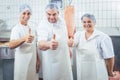 Team of butchers showing thumbs up