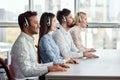 Team of call center operators sitting with put hands on table. Royalty Free Stock Photo