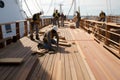 a team of carpenters and builders working on the deck of a ship