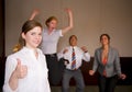 Team Celebration with Woman in Foreground Royalty Free Stock Photo