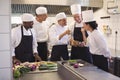 Team of chef tasting food in the commercial kitchen Royalty Free Stock Photo