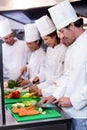 Team of chefs chopping vegetables Royalty Free Stock Photo
