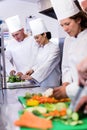 Team of chefs chopping vegetables Royalty Free Stock Photo