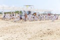 A team of children in kimonos are doing exercises on a sandy beach by the sea. 2023-06-15, Anapa, Russia