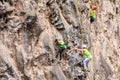 Team Of Climbers Climbing A Rock Wall