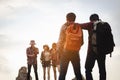 Team of climbers man and woman hiker hiking mountain climbing success stand at the cliff with backpacks on mountain top over. Royalty Free Stock Photo