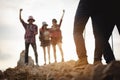 Team of climbers man and woman hiker hiking mountain climbing success stand at the cliff with backpacks on mountain top over. Royalty Free Stock Photo