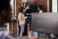 Team of coders talking about algorithms in front of big screen